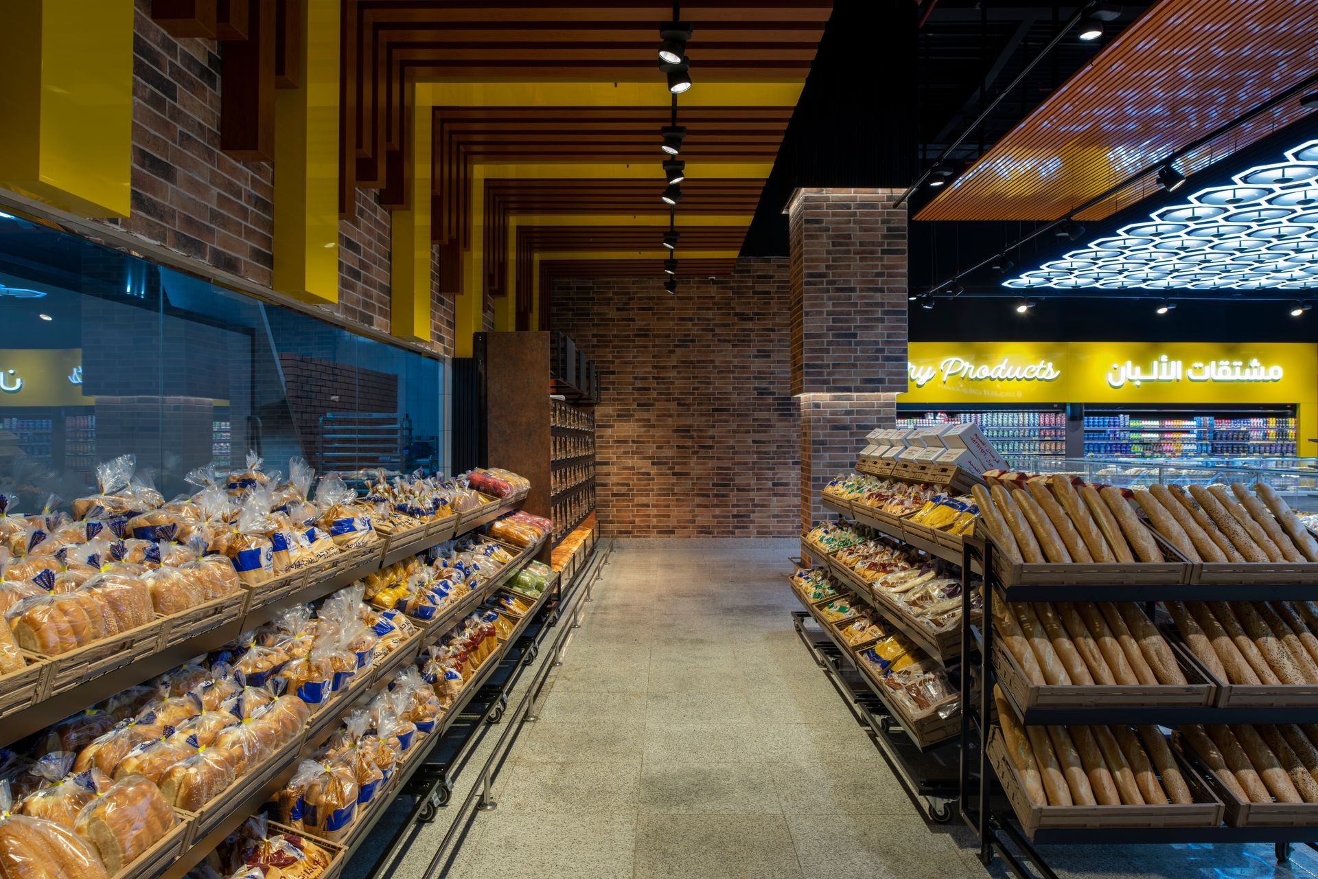 Interior of a supermarket bakery section with shelves filled with various types of breads and baked goods.